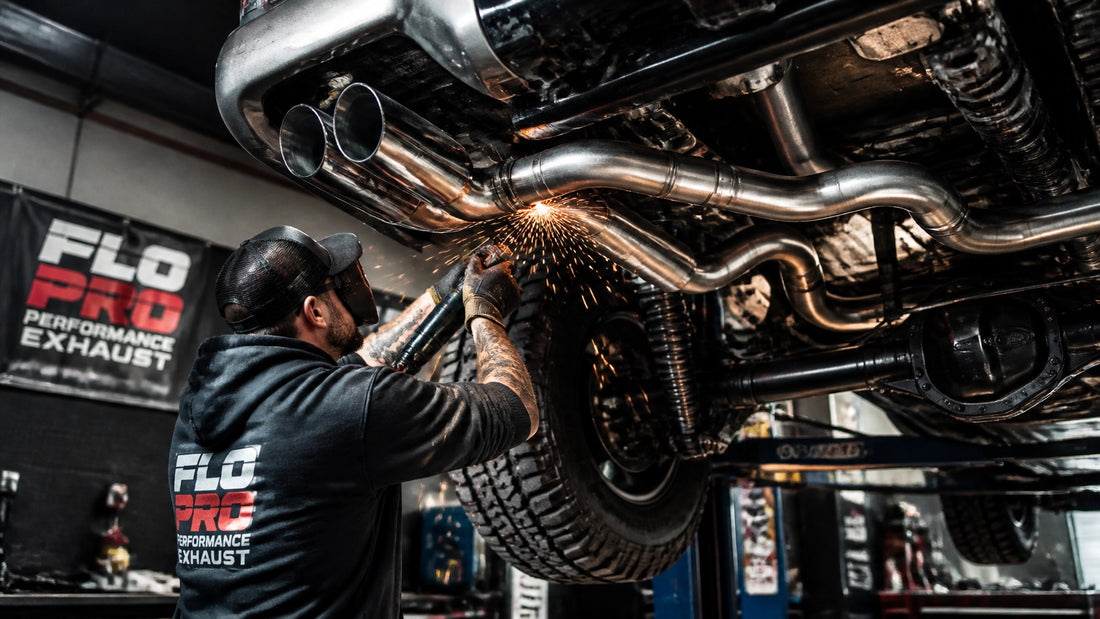 Truck exhaust upgrade installation in a modern automotive garage