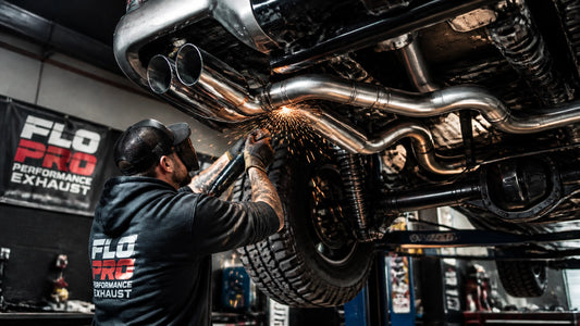 Truck exhaust upgrade installation in a modern automotive garage